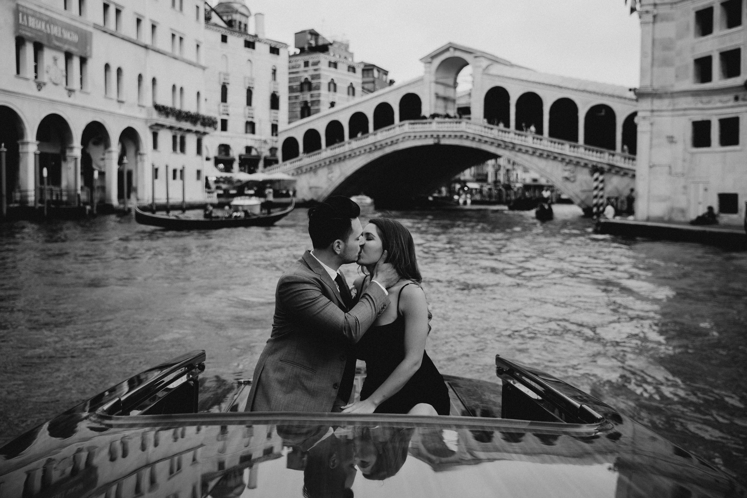 Venice engagement photographer - rialto bridge surprise proposal luxury wooden water taxi clooney style